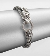 From the Naga Collection. This zodiac-inspired style from a socially and environmentally responsible brand features sterling silver dragon and a brilliant diamond encrusted hoop. Sterling silverDiamonds, .45 tcwLength, about 7.25Hinged clasp closureImported