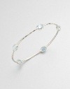 From the Rock Candy® Collection. Five faceted blue topaz stations set on a hammered sterling silver bangle. Blue topazSterling silverDiameter, about 2.5Slip-on styleImported 