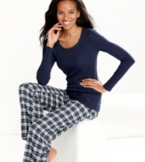 Relax in complete comfort in these pajamas by Nautica. The scoop neck maritime top features an anchor logo on the lower corner of the shirt, while the roomy pants feature contrasting satin lining on the inside of the elastic waistband.