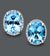 Like staring into two clear, blue pools. These bright earrings feature oval-cut blue topaz (4 ct. t.w.) and round-cut diamond (1/8 ct. t.w.). Crafted in 14k white gold. Approximate diameter: 1/2 inch.