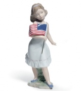 Get a little patriotic. An all-American girl clutches the flag in the delicately handcrafted Let Freedom Ring! porcelain figurine by Lladro.