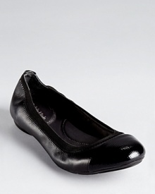 A lizard embossed cap toe lends an unexpected touch to Calvin Klein's Page flats, trimmed in elastic for flexible comfort.