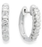 Lighten your look with luminous sparkle. Crafted in 14k white gold, these huggie hoop earrings delight with five, round-cut diamond stations (1/2 ct. t.w.). Approximate drop: 10-1/2 mm.