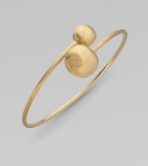 From the Africa Collection. Two textured orbs cross paths along a thin 18k yellow gold band.18k yellow gold Diameter, about 7 Made in Italy 