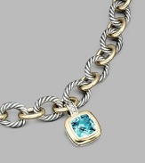 From the Albion Collection. A brilliant blue topaz, richly faceted, surrounded by 18k gold and set in sterling silver. Blue topaz 18k yellow gold and sterling silver About ½ square Hinged clip clasp Made in USA Please note: Necklace sold separately.