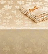 Elegance with an autumnal twist. Featuring a leafy damask pattern in warm ivory, the round Dinner Party Bountiful tablecloth outfits your harvest table in seasonal splendor. (Clearance)