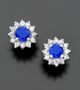 Earrings from the Effy Collection create a rich, regal look. Royalty-inspired stud earrings feature round-cut sapphires (5/8 ct. t.w.) surrounded by sparkling round-cut diamonds (1/4 ct. t.w.). Crafted in 14k white gold. Approximate diameter: 1/3 inch.