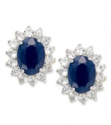 Regale yourself with something regal. Victoria Townsend's royalty-inspired stud earrings feature oval-cut sapphires (3 ct. t.w.) encircled by round-cut white topaz (1-1/10 ct. t.w.). Set in 18k gold over sterling silver. Approximate diameter: 1/2 inch.