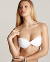 A twisted bandeau bikini top from PilyQ shines in bright white--a shimmering gold tie at the back lends a sparkling finish.