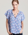 A Tucker floral blouse infuses your days with a youthful spirit and fresh femininity that defines the tone of summer.