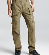 We love the deconstructed look of this slim fit pant. It's inspired by army fatigues and updated with a hodge-podge of cargo pockets, paint spatters and distressed details.