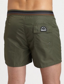 Comfortable swim trunks, in quick-drying nylon, are highlighted by a striped detail along the waistband and back flap pocket with grip-tape closure.Snap button-frontRear flap pocketInseam, about 3NylonMachine washImported