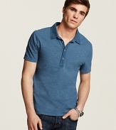 Updated polo with slim fit, extra long button placket and allover slub texture.