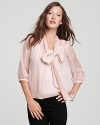 A modern take on prim and proper, this GUESS blouse touts a charming bow at the neckline for a feminine edge.