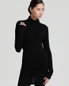 A pullover Donna Karan New York stretch turtleneck is anything but basic, ruched and draped at the back for a most flattering fit and fashion-forward finish.