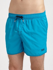 Stylish swim trunks are both sporty and functional, rendered in quick-drying nylon.Elastic drawstring waistSide slash, back flap pocketsInseam, about 4PolyamideMachine washImported