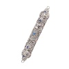 A stunning mezuzah with intricate filigree work, a silver-tone metal finish and hand-set aquamarine Swarovski® crystals.