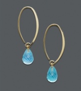 A tropical delight - ocean blue drops in gold transform any look to the exotic. 14k gold oval hoop earrings feature a dazzling, faceted blue topaz teardrop (8-3/4 ct. t.w.). Approximate diameter: 1-1/2 inches.