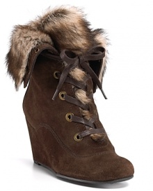 Lace-up wedge booties hit high-level luxe in soft fur and supple suede. By Stuart Weitzman.