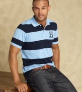 Trim down your summer wardrobe with this slim-fit polo shirt from Tommy Hilfiger.