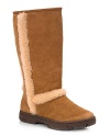 The Classic Tall UGG® now with decorative shearling trim along side and back seams. Twin faced sheepskin with suede heel guard upper and molded EVA outsole. Genuine sheepskin sock naturally wicks away moisture and keeps feet dry. Rubber wafer sole.