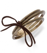 Tastefully textured. This set of 3 bangle bracelets from Lauren Ralph Lauren features ribbed detail and a suede cord tying it all together. Crafted in gold tone mixed metal. Approximate diameter: 2-3/4 inches.