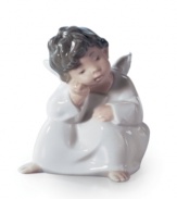 Thinking strictly warm and happy thoughts, this Lladro angel figurine watches over you and your loved ones with quiet grace.