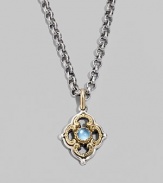 Chic little blossom accent in gleaming sterling silver and 18k gold, centered with a smooth cabochon blue topaz stone. Chain sold separately About ½W X ¾H Imported