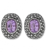 Perfect your look with polished studs. Genevieve & Grace's oval-shaped earrings feature amethyst centers (3-5/8 ct. t.w.) surrounded by glittering marcasite. Set in sterling silver. Earrings feature an omega clip-on backing for non-pierced ears. Approximate length: 3/4 inch. Approximate width: 5/8 inch.