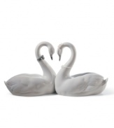 Exquisitely crafted of porcelain, the Endless Love figurine by Lladro presents a pair of snowy swans united in love. Designed as a wedding cake topper, or a bridal or anniversary gift, this heirloom quality collectible will be cherished for generations to come. 5.25 x 10.5.