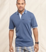 Nothing tops the classic look of this solid polo shirt from Tommy Hilfiger.