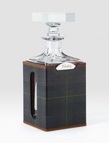 Encased in a plaid saddle leather sleeve, a gleaming lead crystal decanter with a rotating stainless-steel nameplate engraved with a selection of spirits: Vodka, Whiskey, Rum, Scotch or Gin.26 ounces3¾L x 9H x 3¾DHand washImported