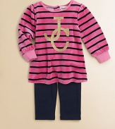 Crafted in plush velour, this stunning tunic features bold stripes and glimmering logo detail, paired with cozy leggings. Tunic Round necklineLong sleevesBack snaps Leggings Elastic waistbandCotton/Polyester/SpandexMachine washImported Please note: Number of snaps may vary depending on size ordered. 