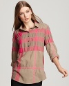 Bright pink makes waves against classic military khaki on this iconic Burberry Brit tunic.