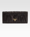 Dramatic pleating in supple lambskin opens up to ten credit card slots and four billfold compartments.Goldtone logo detail Snap closure Inside zipper Lambskin lining 7½W X 3½H X ½D Made in Italy