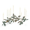 Michael Aram gets inspirations for his handcrafted metal artwork pieces from nature. The olive branch candleholder has nine taper candlestick cups with one cup slightly taller than the others, allowing the piece to function as a menorah. 17 long and constructed in oxidized bronze.