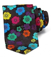 Make your professional look pop. Bold stylized flowers adorn this luxurious textured silk tie from duchamp.