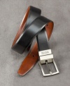 A double-faced belt with head-turning style. Aniline-dyed genuine bridle-leather strap has a deep, rich color and subtle sheen. Rotating metal buckle has a satin finish and engraved logo. Buckle rotates to reverse the belt from black to brown so it can be worn in a variety of settings.