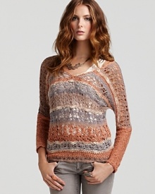 A loose-knit Free People sweater features an alluring v back and mélange of fall-perfect hues for an eclectic look to update weekend denim. Work the crochet style all season long, wearing it solo or layered over tanks and button-downs.