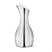 The Georg Jensen Legacy collection is a perfect illustration of how a more decorative style incorporated into modern design can result in a gorgeous piece - the smooth, curved surfaces are mirroring their surroundings in a world of glittering sumptuousness. The Georg Jensen Legacy pitcher is ideal for pouring water or juice, for example. The decorative grooves provide a firm grip while the pitcher insulating design ensures that ice water stays cold for a while. The Georg Jensen Legacy pitcher is made of stainless steel and comes with an elegant white stopper.