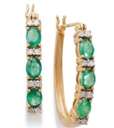 Glam in green. These 14k gold hoop earrings get a sparkling update with oval-cut emeralds (1 ct. t.w.) and sparkling round-cut diamonds (1/8 ct. t.w.). Approximate diameter: 3/5 inch.