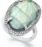 Inspired by nature, this stunning cocktail ring highlights an organically-shaped labradorite (11-1/2 ct. t.w.) stone surrounded by round-cut diamonds (1/4 ct. t.w.). Set in sterling silver. Stone size: 5/8 inch. Ring Size 7.