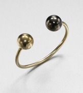 A modern and architectural design featuring two-tone spheres on a narrow cuff. 14k goldplatedGunmetal-finishedDiameter, about 2.4Slip-on styleMade in USA