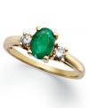 Enviable green hues. This vibrant 14k gold ring features an oval-cut emerald (7/8 ct. t.w.) and round-cut diamond side stones (1/5 ct. t.w.).