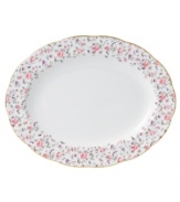 Scattered with dainty blooms, the Rose Confetti oval platter restores the grace and charm of another era in fine bone china from Royal Albert. A scalloped edge with gold banding and a traditionally feminine palette add to its romantic sensibility.