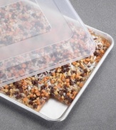 Creating just the right amount of crispy treats, brownies and cookies has never been easier on this half sheet with a natural aluminum core for even baking and great success. Handy lid pops on to keep contents safe and secure on the way to school, brunch or keep them fresh for another day. Lifetime warranty.