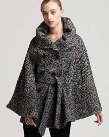 Ever-so chic, this Calvin Klein cape is rendered in a herringbone bouclé for the epitome of city style. The effortless finishing touch to your day-to-night look, it will take you from fall into winter with sophisticated luxury.