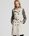 A bold geometric pattern accents the sleeves and collar of a classic Burberry trench coat. With subtle retro appeal, this is a one-of-a-kind statement piece.