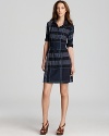 Statement plaid emblazons this sleek Burberry shirt dress, while standout aqua stitching adds a youthful flair for a modern spin on a cool classic.