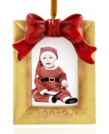 Never forget it! Wrapped in a red bow, this goldtone picture frame ornaments your tree with a special holiday memory. Dated 2012.